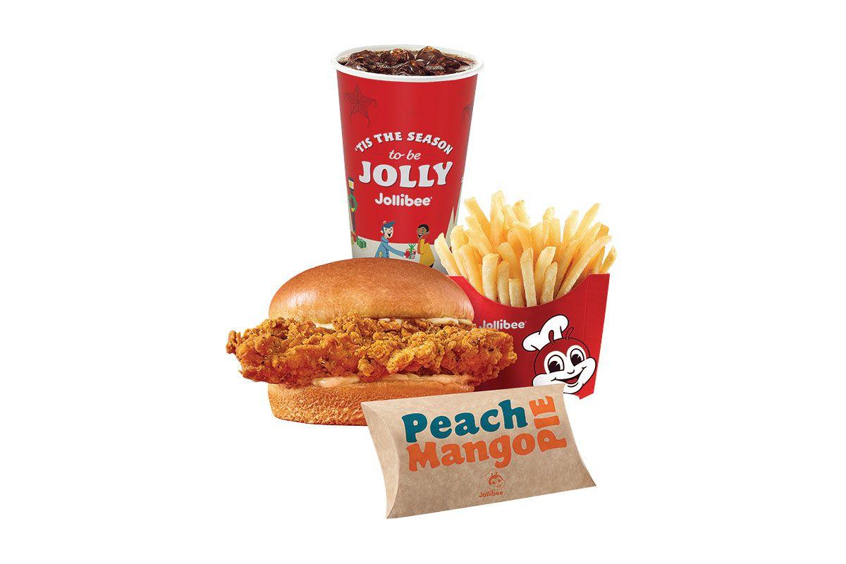 A picture of a chicken sandwich with fries, pie, and a fountain drink on a white background